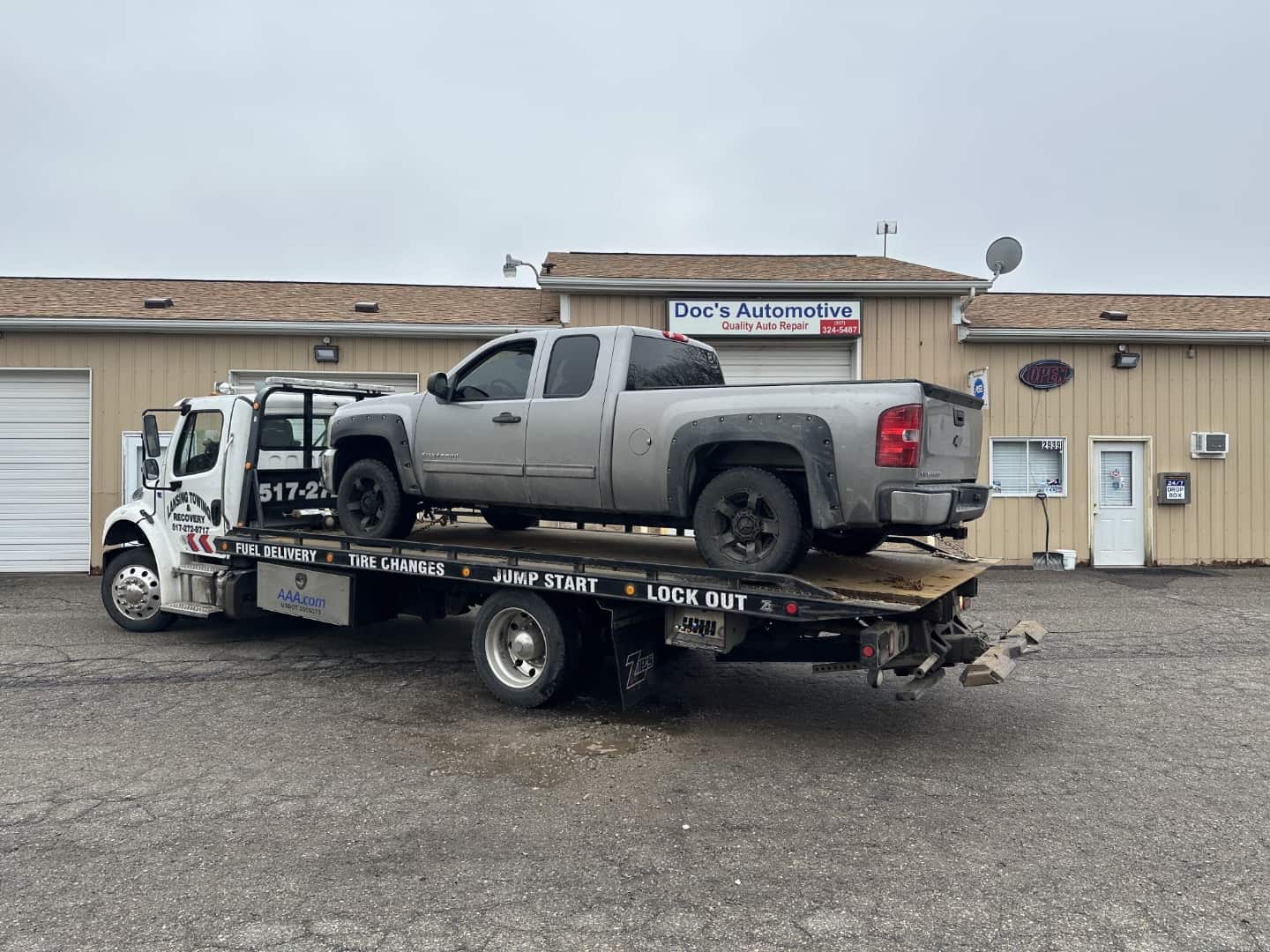 Picture of my 2013 Chevy Silverado on the back of a flatbed tow truck